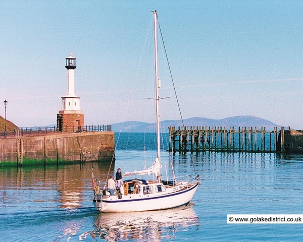 Yacht leaving Maryport Harbour, Cumbria Yacht leaving Maryport Harbour, Cumbria